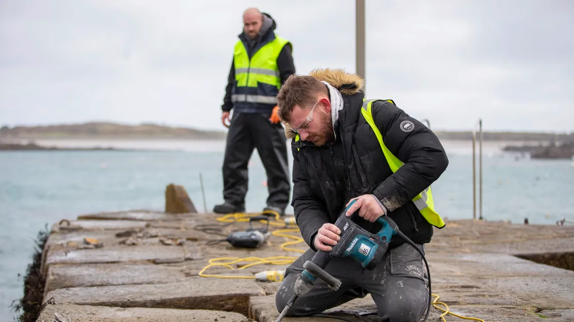 Work has started on repairing the damage to Rousse Pier. Site foreman Gareth Jones, left, and Will Konken get to work. (Picture by Luke Le Prevost, 30451765)