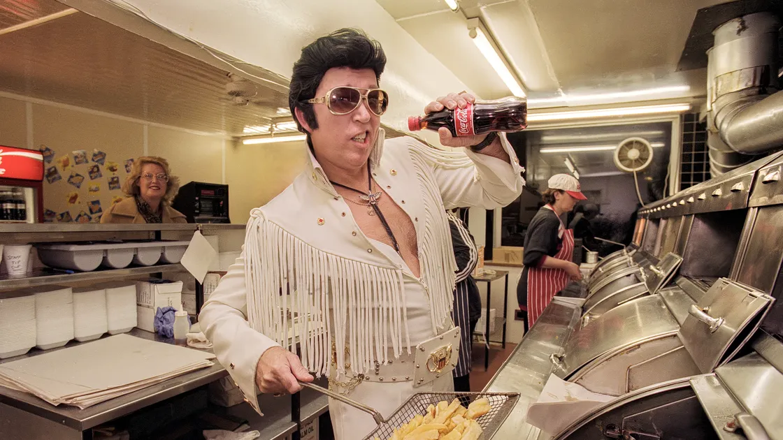 Elvis impersonator Brian Richards at the Arsenal Chippy in 1998