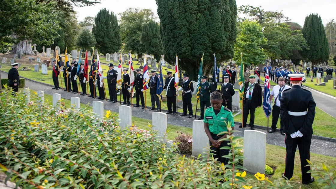 A St John Ambulance member laid a wreath at yesterday’s remembrance service. (Pictures by Andrew Le Poidevin)