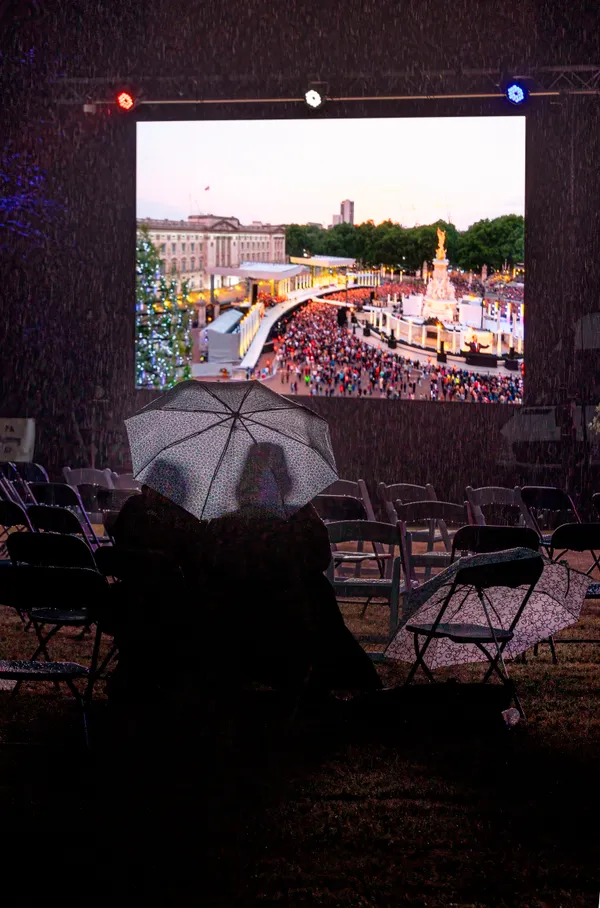 Heavy rain did not stop some hardy people from enjoying all of the Platinum Party at the Palace, which was shown live from London on a big screen.  (Picture by Chris George)