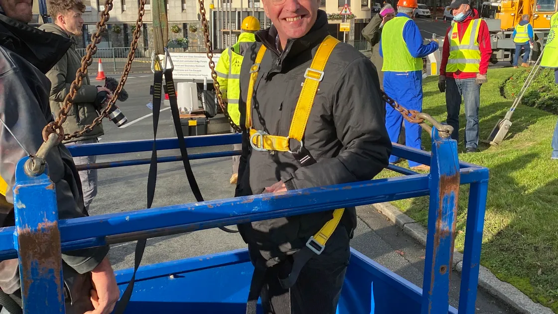 Bailiff Richard McMahon volunteered to put the star on the top of the Rotary Club of Guernsey Club's Tree or Joy on the roundabout. Picture supplied by Jerry Girard (30225778)