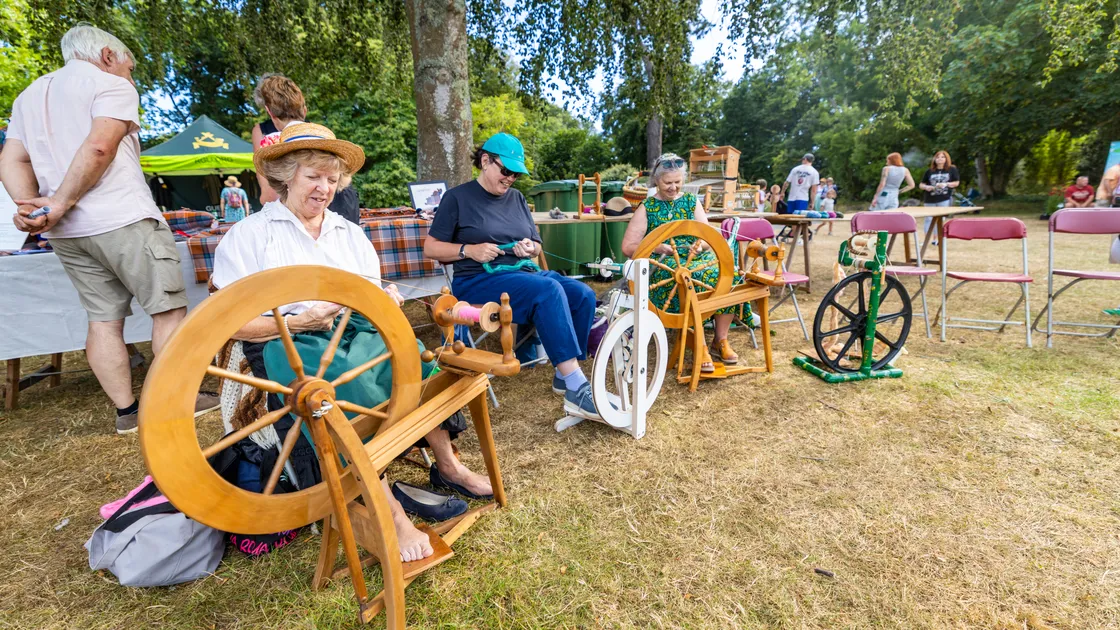 Left to right, Karen Malledent, Ceri Turton and Jane Duchemin spinning yarn at yesterday’s La Viaer Marchi staged by the National Trust of Guernsey at Saumarez Park.