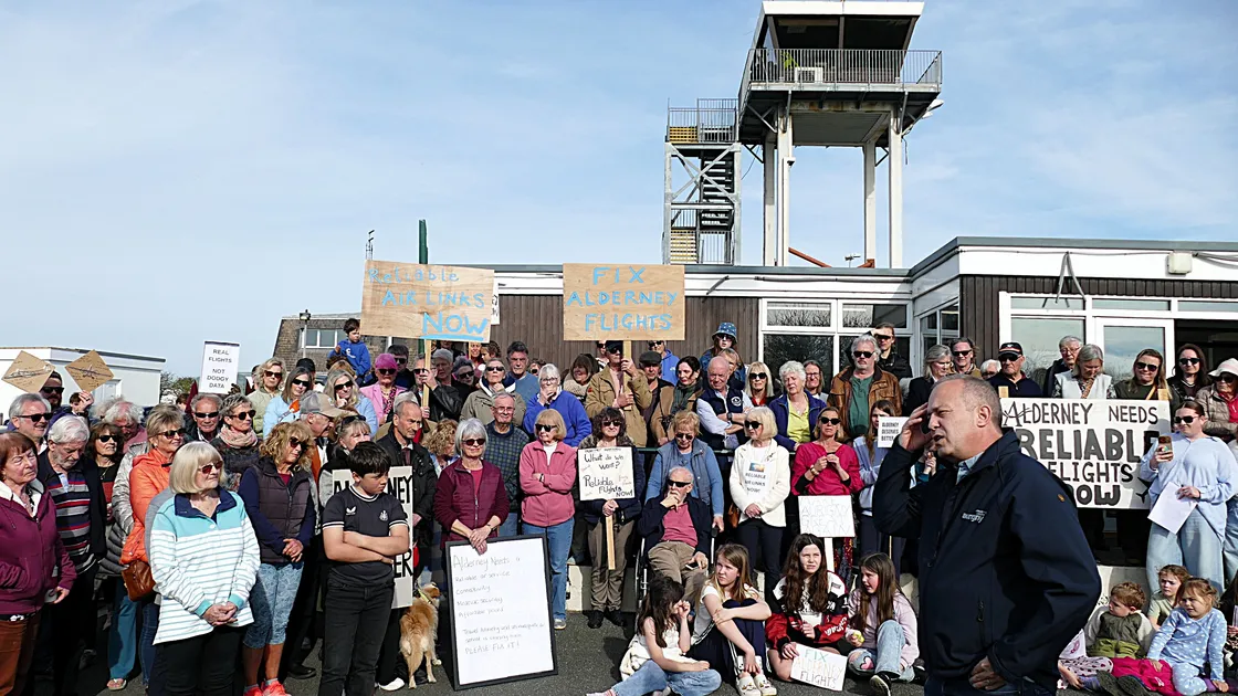 There has been a flurry of activity around Alderney's air connections since this protest meeting, addressed by Aurigny CEO Nico Bezuidenhout (pictured front right), was held on Sunday afternoon. 							 (Picture by David Nash)