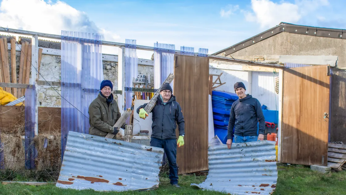 Rocquaine Regatta committee members, from left, Mark de Garis, Jon Collenette and Pierre Lenfestey, with part of the roofing that blew off the shed used to store regatta items