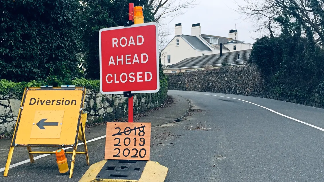 Road closure sign which has been modified by a member of the public.  (23513608)