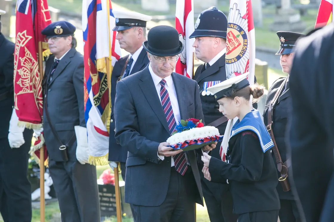 Pic by Adrian Miller 27-09-20 Foulon Cemetery. Remembrance service for H.M.S. Charybdis and H.M.S. Limbourne . Wreath Bearer Cadet Browning 13 of the Sea Cadets leads the Bailiff Richard McMahon. (28735069)