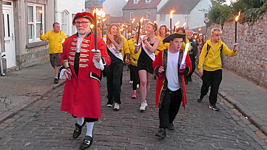 The customary torchlight procession through St Anne brought Alderney Week to a close on Saturday evening.