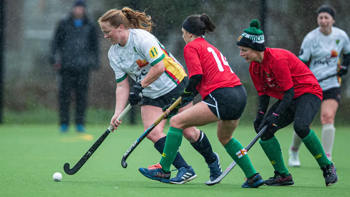 Teya Sheppard on the ball for Sarnian Sticks as she is closed down by Laura Campbell and Mix Byrom
