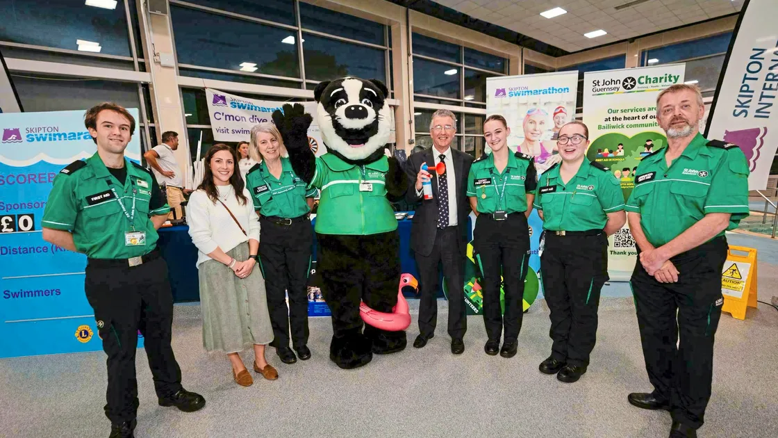 The Bailiff Sir Richard McMahon sounds the horn for the start of the Skipton Swimarathon
