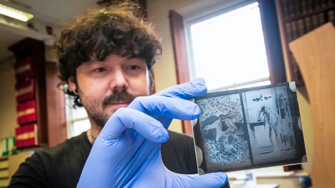 Library assistant Mike Lowe holds a glass negative of two portraits of Victor Hugo. (32932408)