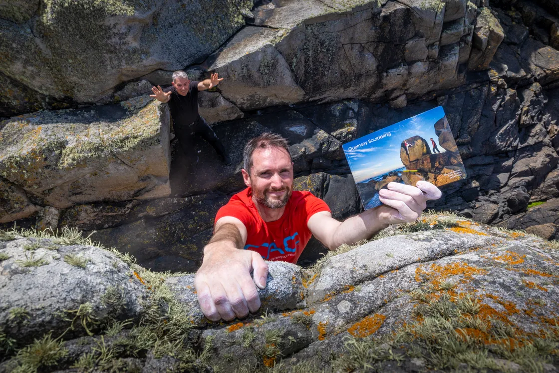 Steve Le Feuvre shows off the new bouldering guide while publisher David Price ‘spots’ from below. 