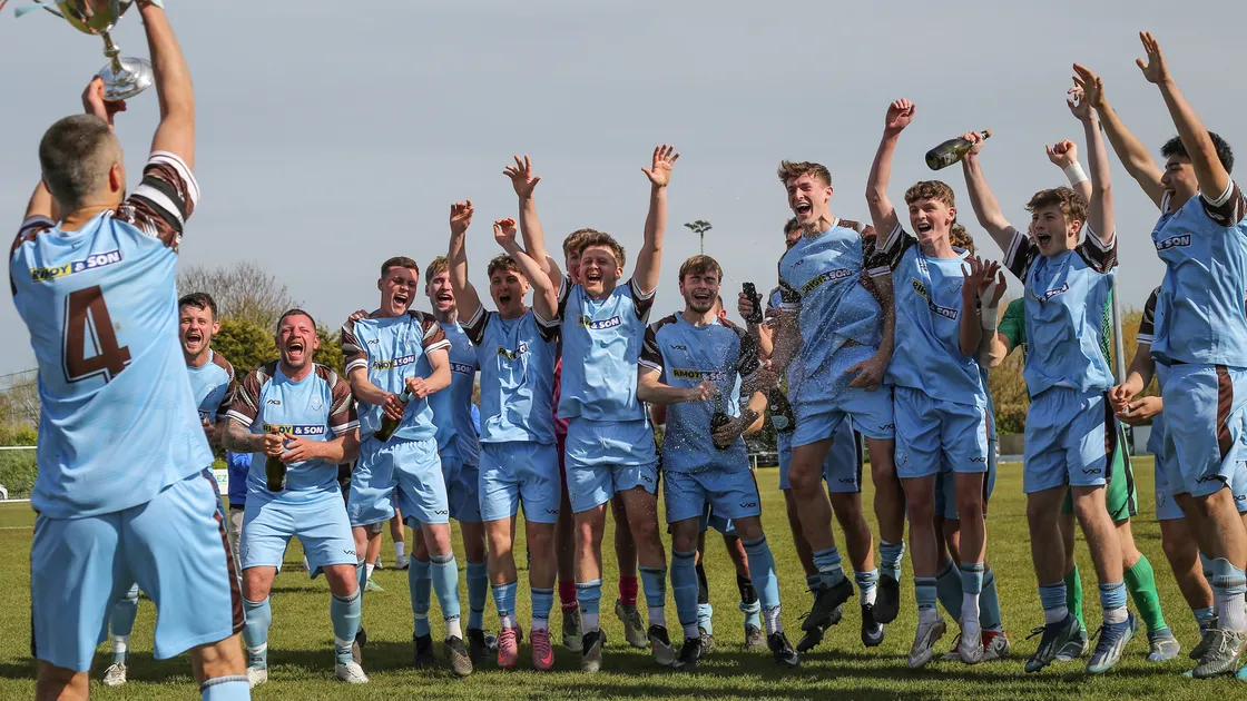 North captain River Marsh lifts the Priaulx Cup as his teammates celebrate.