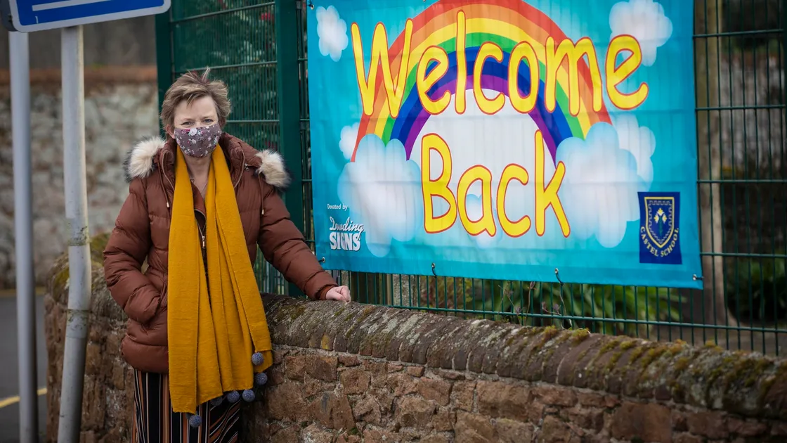 A welcome back banner with a rainbow and head teacher Linda Paley were there to greet Castel Primary School pupils when they went back to school yesterday. (Picture by Peter Frankland, 29314016)