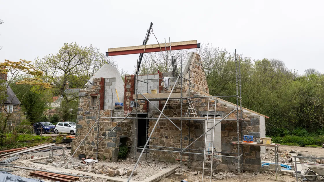 The roof ridge is fitted on the restored barn in Talbot Valley yesterday. 