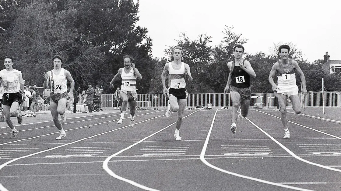 John Allen (1) approaches the line at the 1993 GIAAC Championships, where he placed third behind Darren Le Tissier (18) and Sean Duquemin (7). 