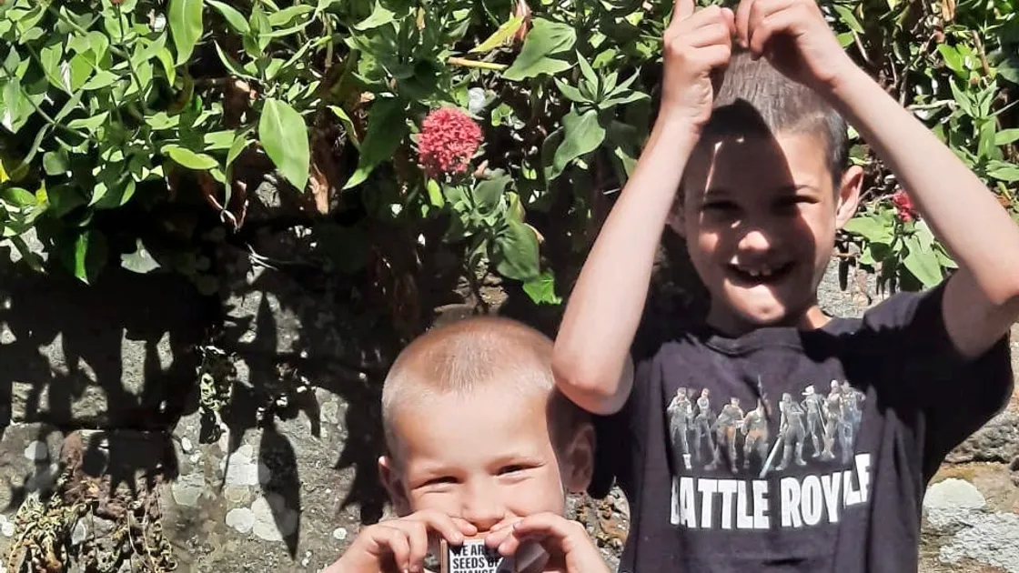 Alfie, 6, and Casey, 9, collecting seeds from one of the Guernsey Electricity wildflower seed stalls.