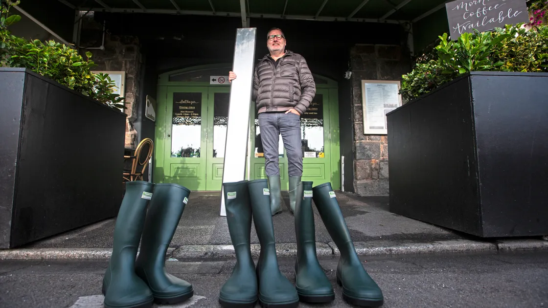 There was no over-topping at high tide in St Peter Port yesterday morning but business owners on the Quay were there to make sure they were not affected. Steve Le Poidevin of Balthazar was ready to supply wellington boots for customers and put up boards to stop the worst of the flooding. (Picture by Peter Frankland, 33610428)