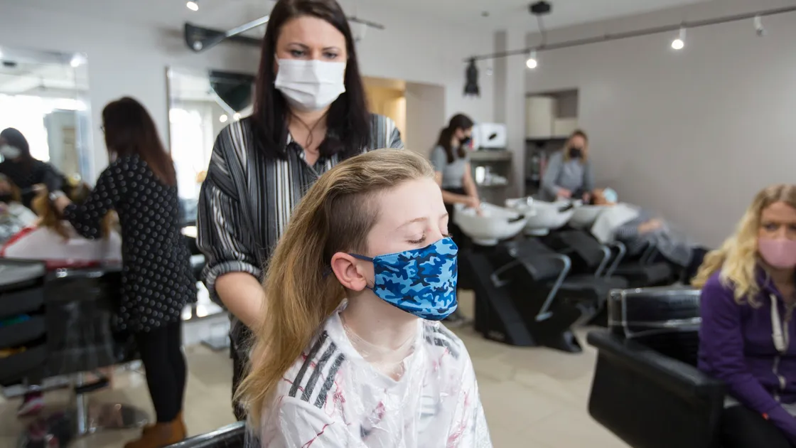 Bijoux Boutique senior stylist Elaine Wesley gets to work on Jacob Morgan's hair. (29331624)