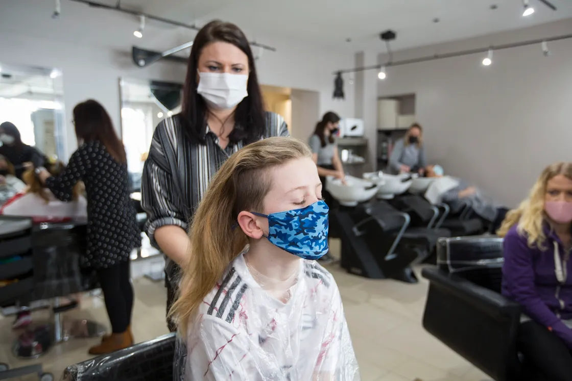 Bijoux Boutique senior stylist Elaine Wesley gets to work on Jacob Morgan's hair. (29331624)