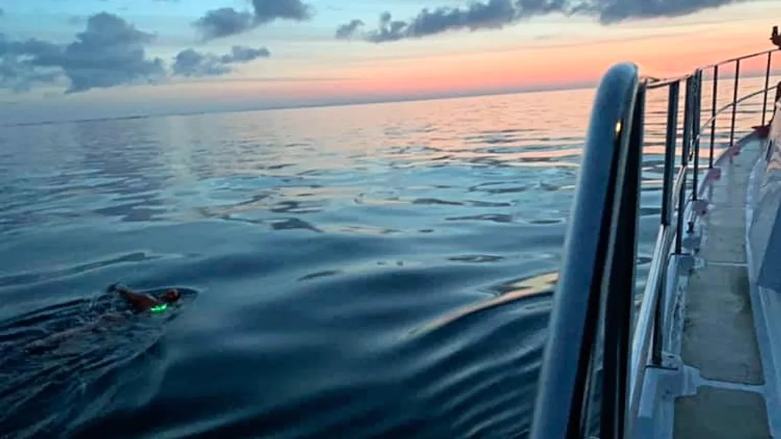Dawn breaks while Justine Riley swims from Jersey to France. (25582429)