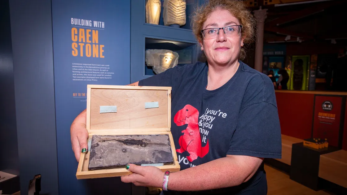 Liz Sweet with ancient fossils on display. (29954163)