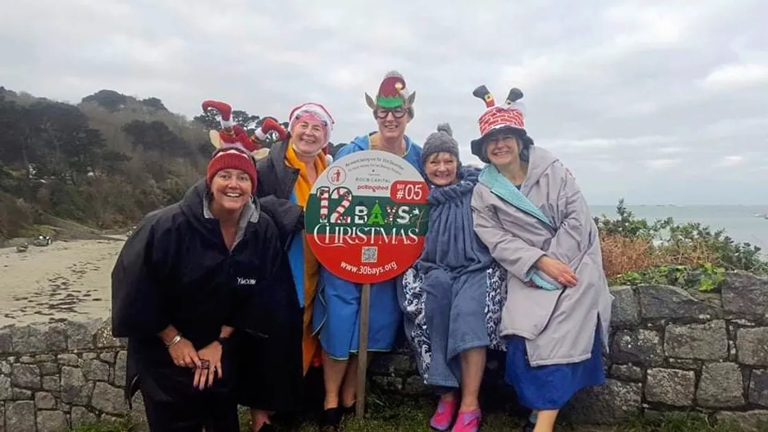 Friends Marina Burr, Carole Atkinson, Mimi Gregory, Michelle Riddle, and Debbie Aldous posed on a beach after taking a mid-December swim for the Twelve Bays of Christmas challenge to raise money for Les Bourgs Hospice. (Submitted photo from Michelle Riddle)