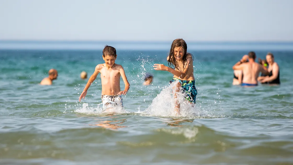 Aaron (8) and Aiden (10) Le Cheminant enjoying the cooling sea water at Pembroke yesterday. (Picture by Luke Le Prevost, 31048362)