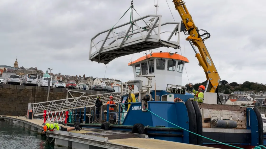 The Sarnia workboat lifting the walk-ashore bridge serving the Swan pontoons out of the water this morning.