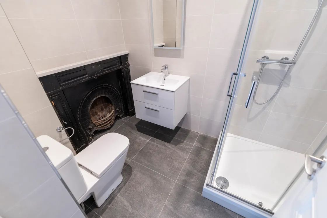 The fireplaces have been retained in the listed buildings, with this one featured in a bathroom. 