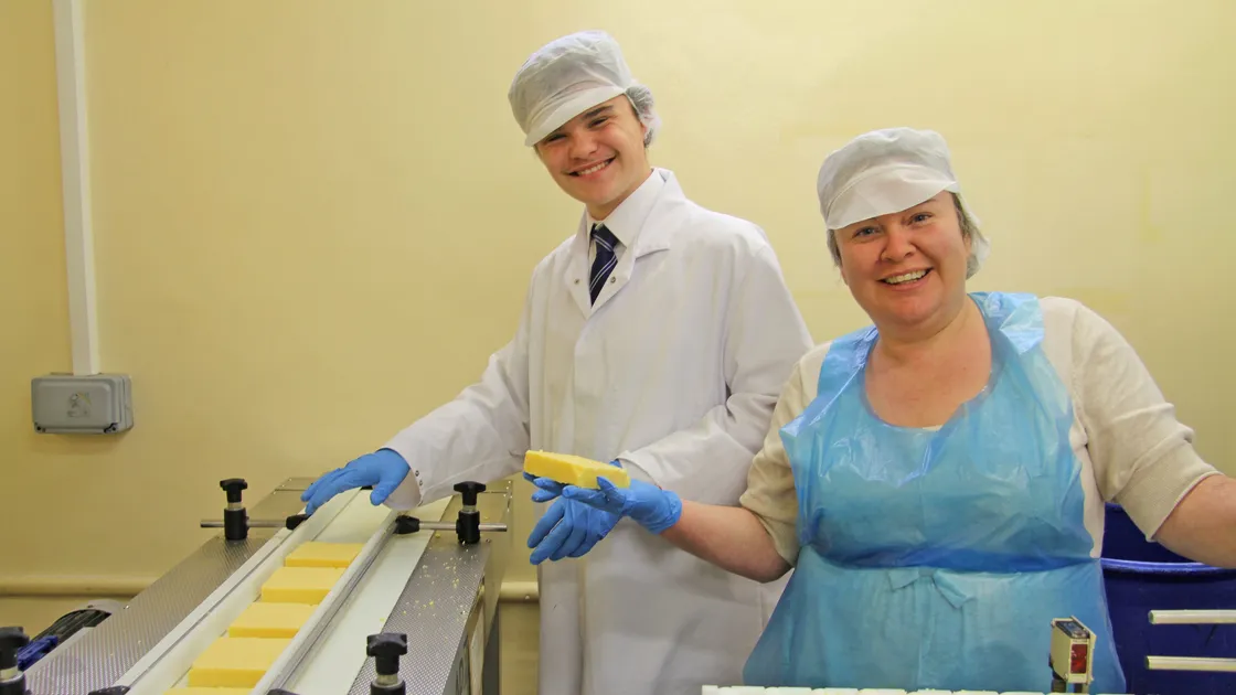 Ernie's mum, Claire Backlund-Leale, and brother Joe labelling and packing Ernie’s (Im)mature Cheddar at Guernsey Dairy.