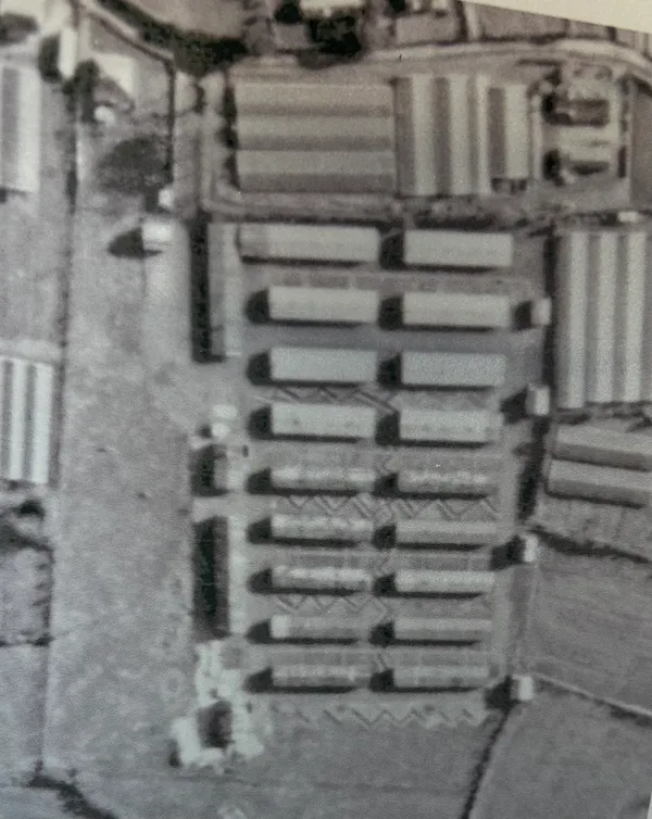 Occupied: War-time and the ground with its array of Nissen huts to house Organisation Todt slave workers. Rue Cohu is at the top of the picture.