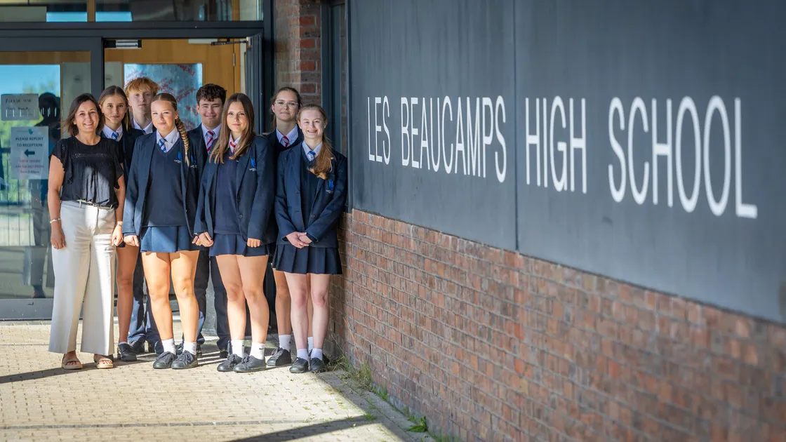 Les Beaucamps School has been recognised as a centre of excellence for geography. Pictured is Emma Worthington, curriculum team leader for Humanities with Year 11 geography students, left to right, Poppy Curtis, Bobby Broughton, Evie Banks, Jack Manning, Ava Worthington, Betty Pearce and Emily Le Page.					 		 (Picture by Peter Frankland, 34961405)