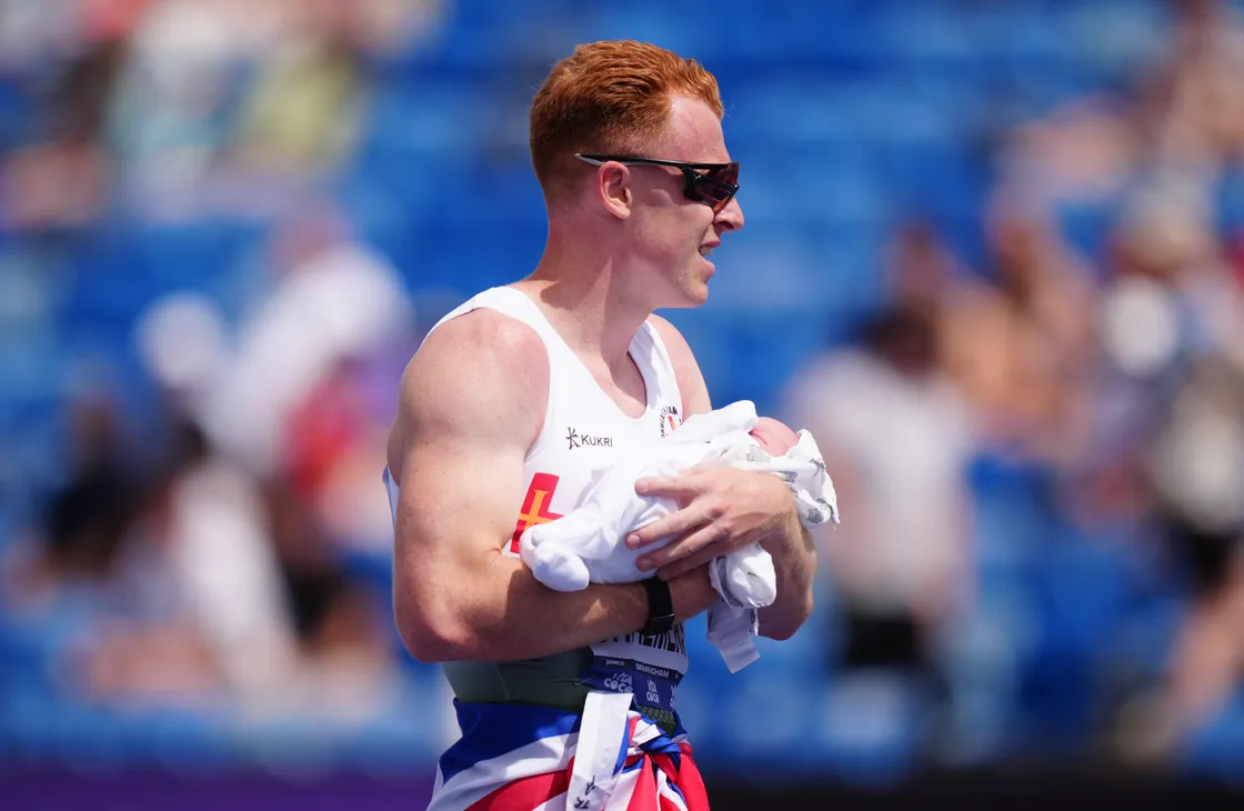 Chalmers celebrating his latest British title with his son, born the week of the championships in Birmingham.