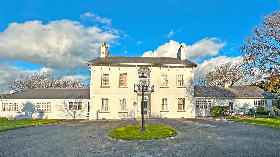 John Arlott’s former home sits within an acre-and-a-half of walled gardens and has six bedrooms.