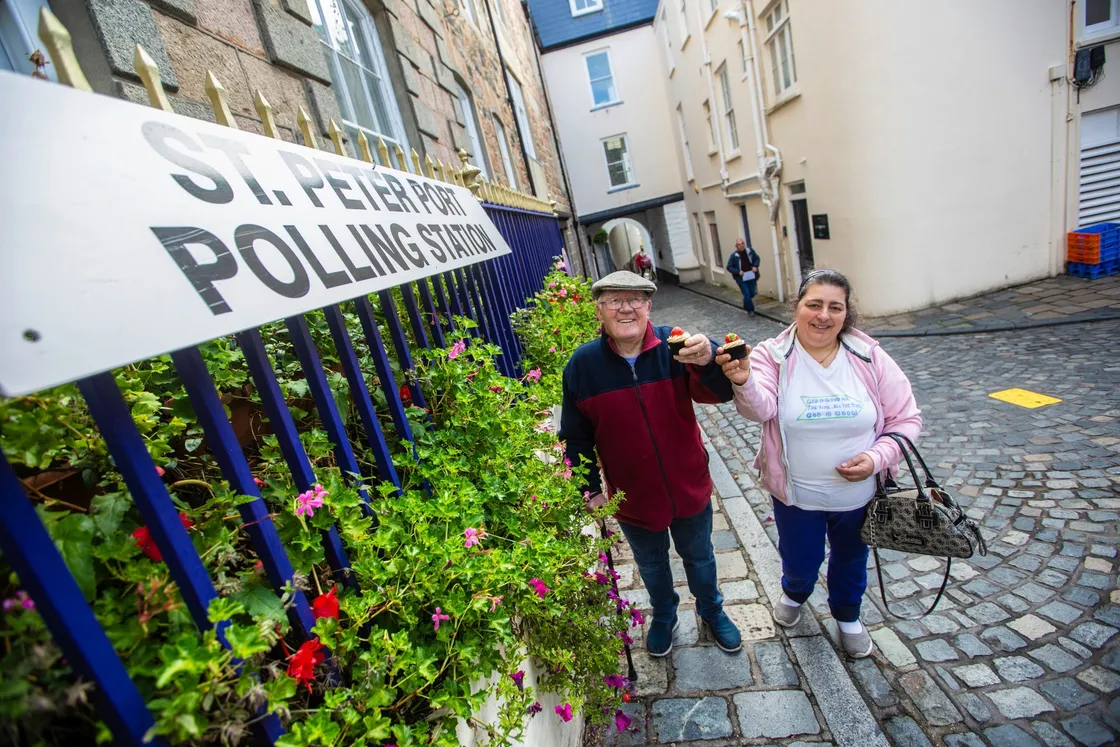 George and Judy Helpe cast their votes at the St Peter Port constables' office and received a cupcake afterwards. (Picture by Peter Frankland, 28773295)