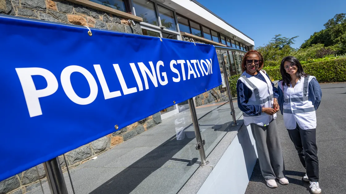 Two of the election observers at the Castel Douzaine Room as voting got under way in last year’s second island-wide election.