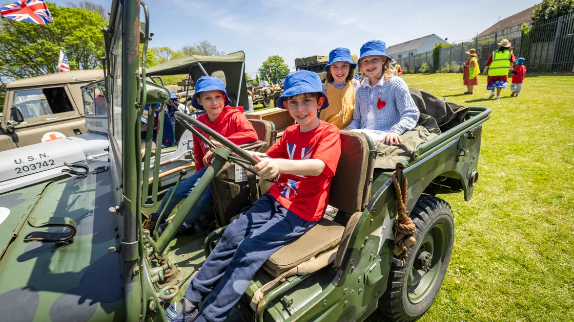 St Martin’s Primary School were learning about the Liberation, Occupation and evacuation, which included a visit from several military vehicles. From left, Zane Knowles Ahmed, Toby Moulin, Juno Bamford and Mollie Boatwright-Smith. (Picture by Sophie Rabey, 34744610)