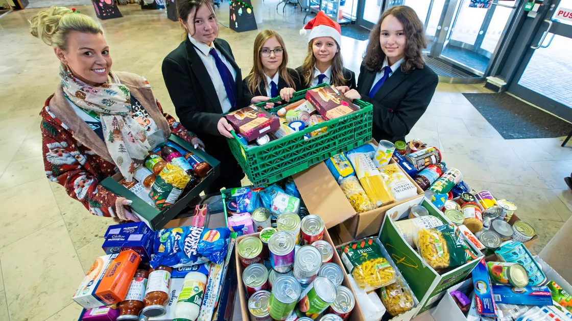 Guernsey Welfare volunteer Donna Patch collecting items donated by St Sampson’s High School pupils. Alongside her are, left to right, Mia De Carteret, Niamh Croft, Gracie Marquand and Eleanor Wadley. (Picture by Peter Frankland, 33880493)