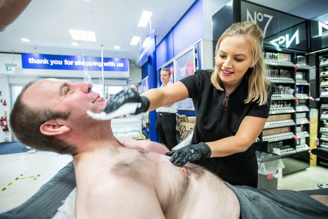 Picture by Sophie Rabey.  04-09-20.  Boots Charity Event Sponsored by All Beauty..The staff in store will be raising money for their chosen local charities buy opting to do a head/beard shave or leg/chest waxing..Samantha Ogier from All Beauty waxing Mike Hawdon who is raising money for GSPCA.. (28653414)