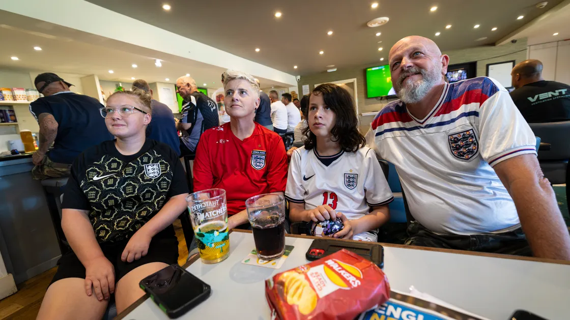 Left to right: Kaci Pratt; Joey Le Blond, Stanley De Mouilpied and Pete De Mouilpied watch England’s match against DR Congo yesterday evening.