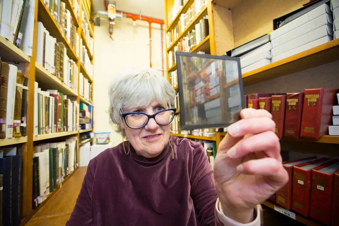 Sue Laker examining one of the many glass plate lantern slides. (29412254)