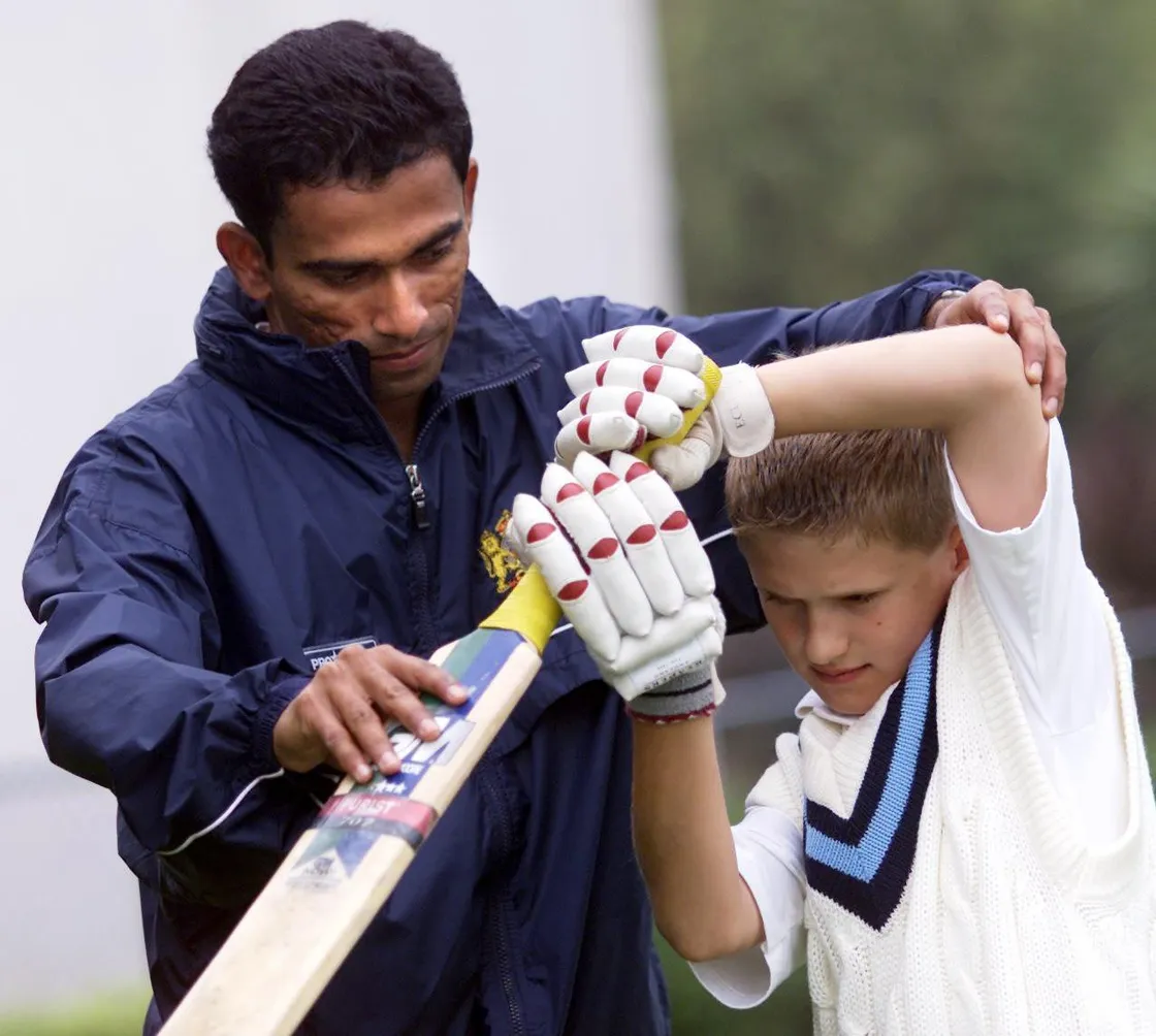 Ami Banerjee coaches a 10-year-old Tim Ravenscroft in 2002. (30543937)