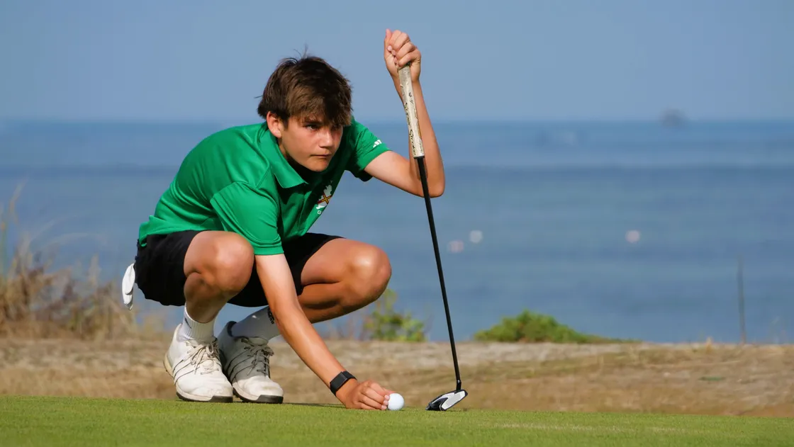 Guernsey’s Josh Neville lines up a putt on Sunday in the CI junior final.