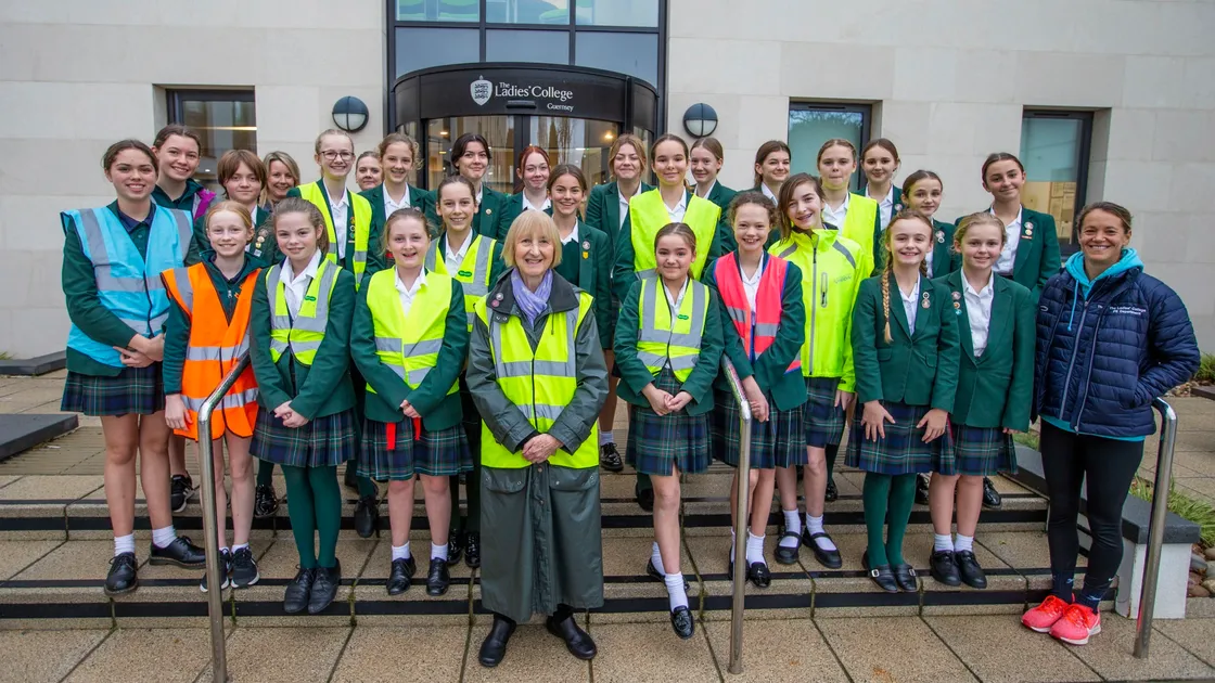 Living Streets Guernsey secretary Pat Wisher, centre, with students and teachers from Ladies’ College, who were among those to receive free hi-vis vests from the road safety group.  (Picture by Sophie Rabey, 28950673)