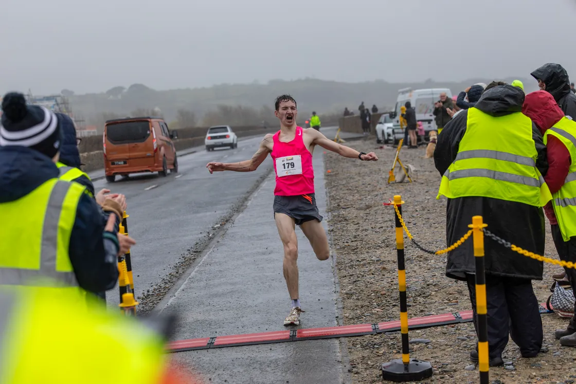 Jack Rees is the first local runner to cross the finish line in fourth overall.