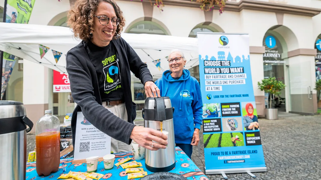 Fairtrade Guernsey Steering Group secretary Hannah Davis pours a brew for Anne Sandwith in Market Square on Saturday