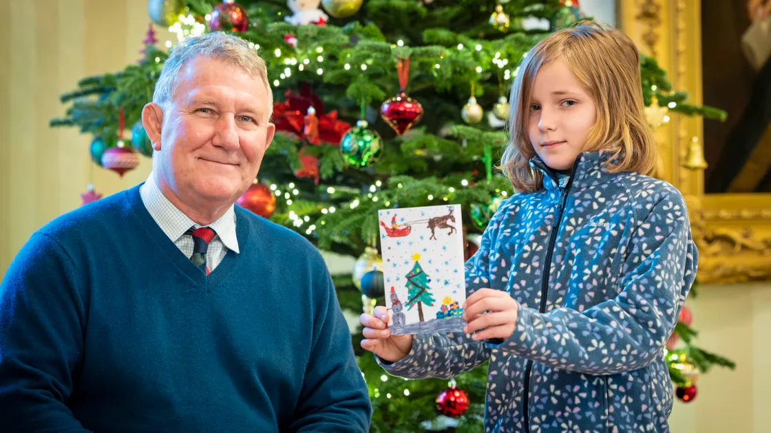 Lt-Governor Sir Richard Cripwell with Cressida Bryce from St Stephen’s Brownies who designed this year’s Christmas card for Government House