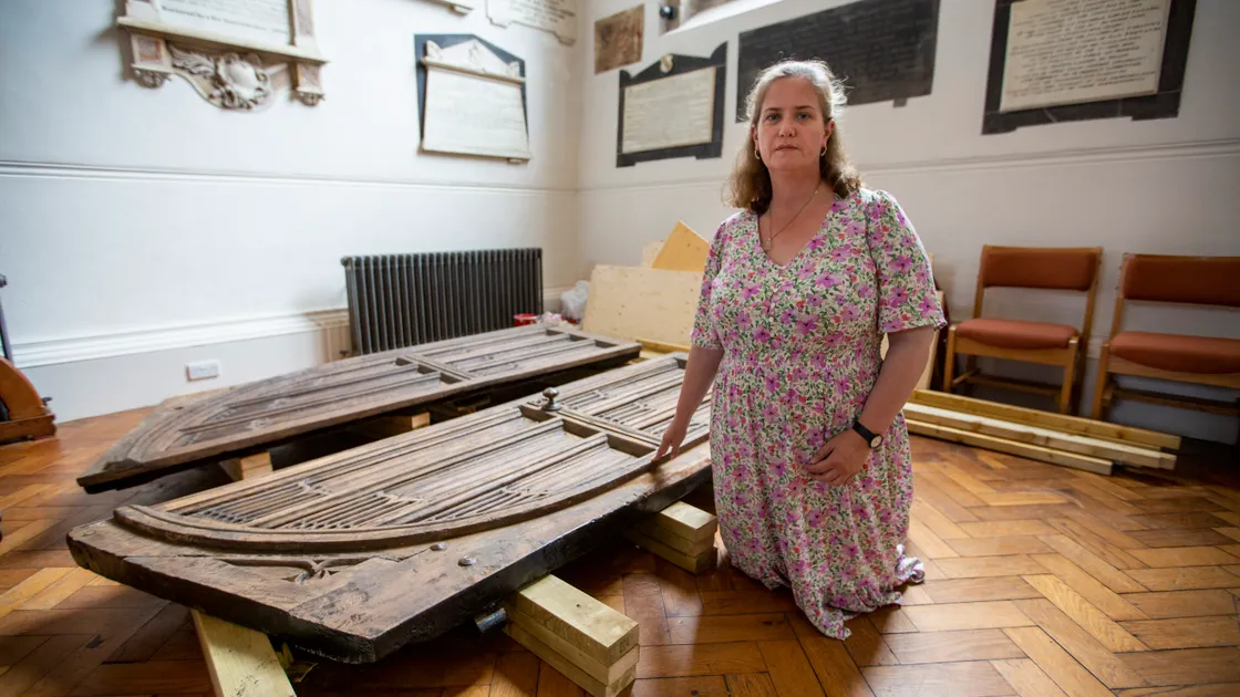 Churchwarden Ruth Abernethy by one of the oak doors from the Town Church, which have been removed for repairs and preservation and which will be hung again 20cm into the church behind glass doors. (Pictures by Luke Le Prevost, 31063822)