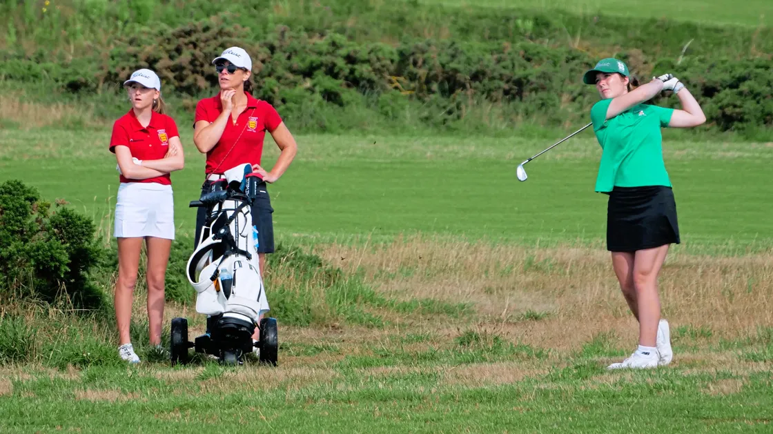 Chloe Gaudion hits an approach shot watched by Anabelle Lucas-Villar in the all-junior CI women's final. (Picture by Gareth Le Prevost, 33459728)