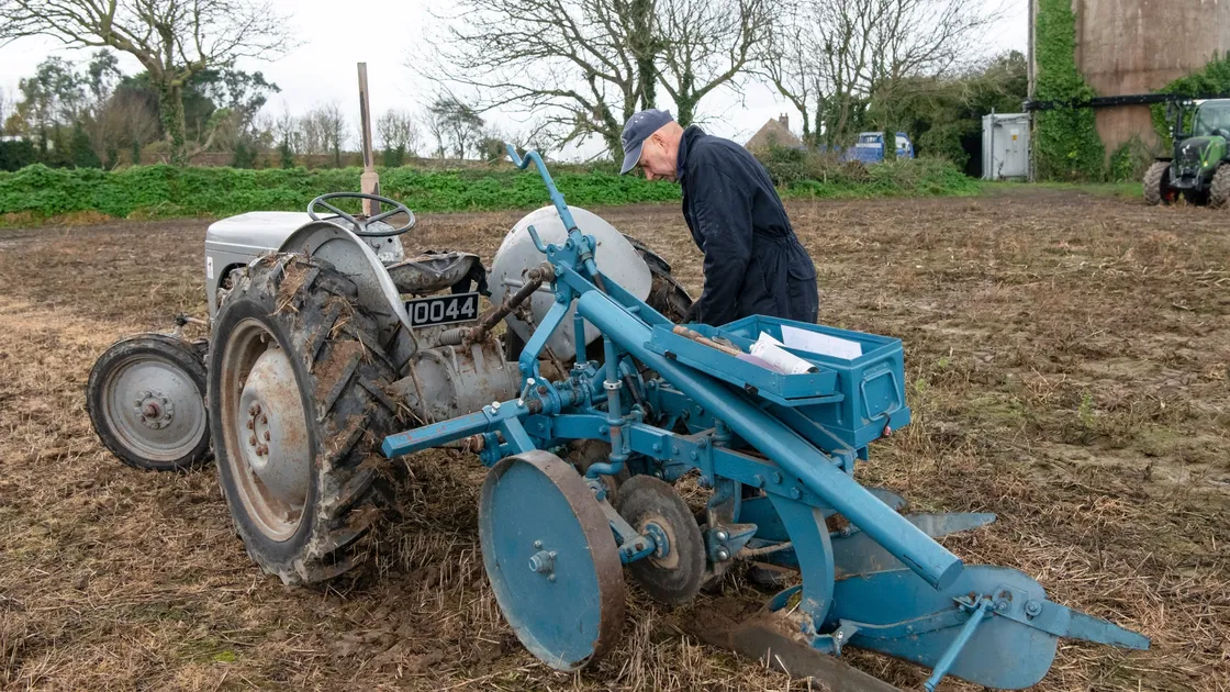 Graham Dorey adjusts the set-up of his plough before completing another furrow.